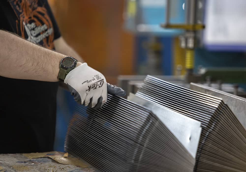 A TAC Industries employee is working on manufacturing and assembly.