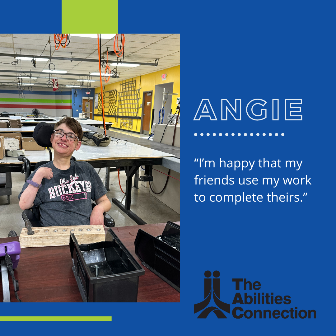 Support In The Workplace: Angie smiling at a table, sharing that she is happy that her friends use her work to complete theirs.