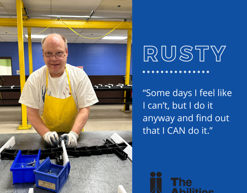 An image of a person (Rusty) who is working on a project for TAC Industries, wearing a yellow apron, showcasing discovering strength. The text displayed says "Rusty", "Some days I feel like I can't, but I do it anyway and find out that I CAN do it."